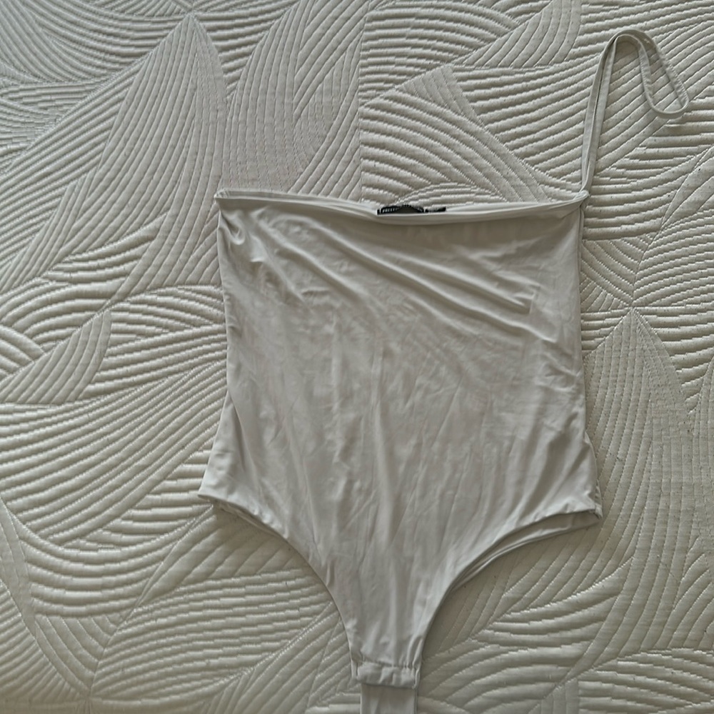 White body suit with one cross strap